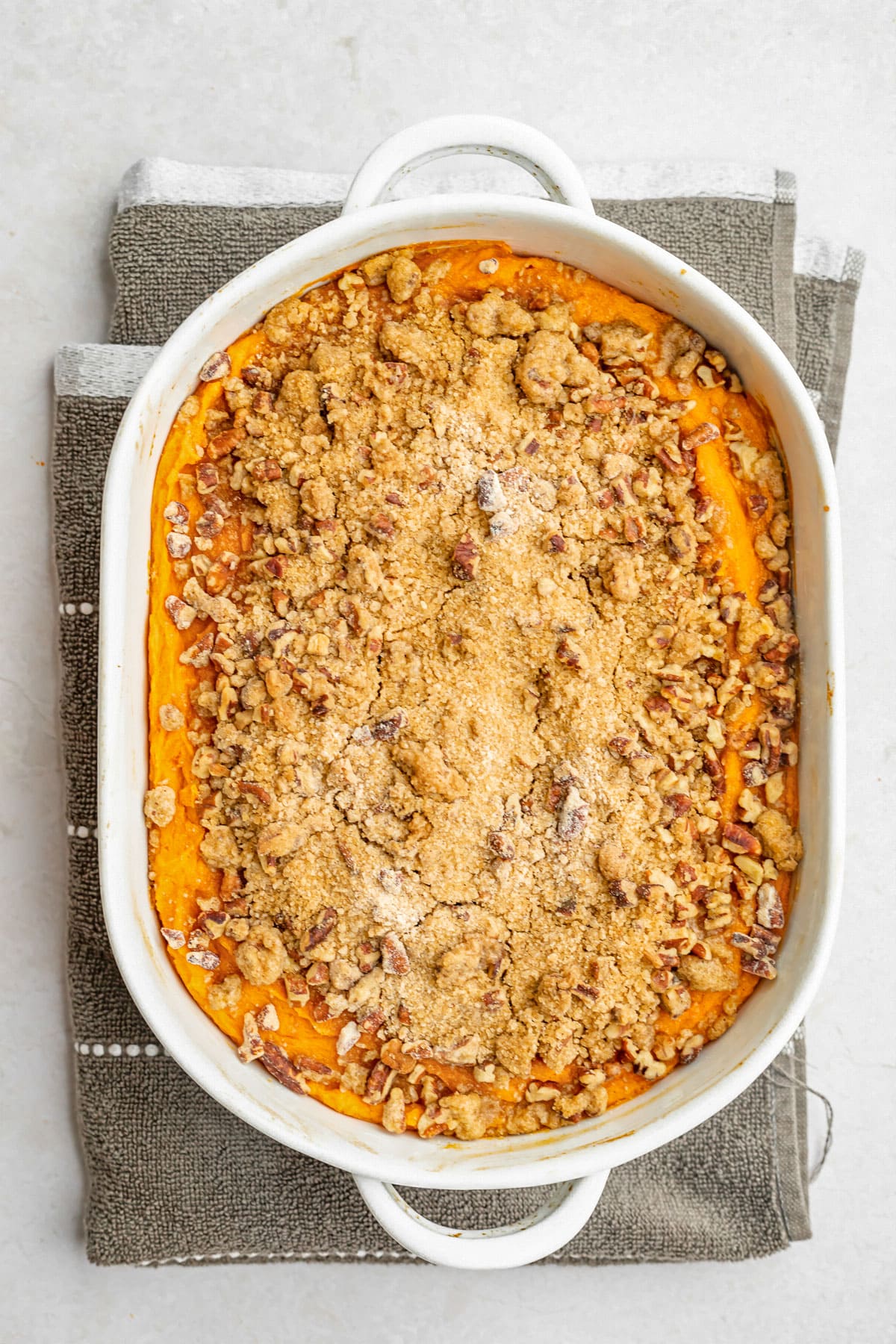 Overhead view of an oval casserole dish holding a sweet potato souffle.