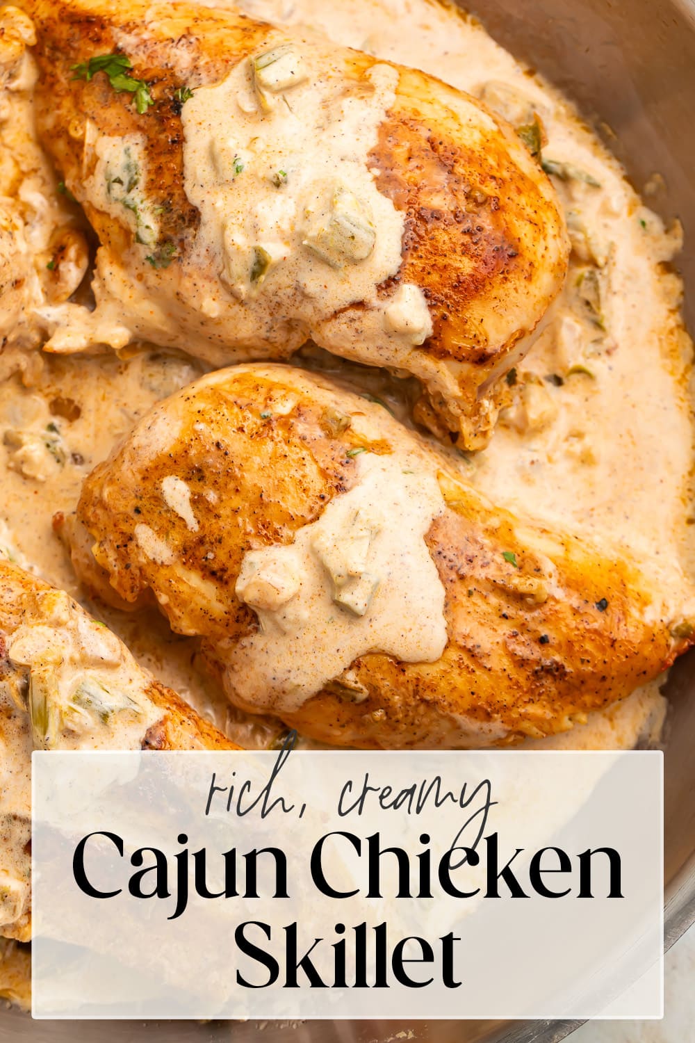 Pin graphic for creamy Cajun chicken skillet.