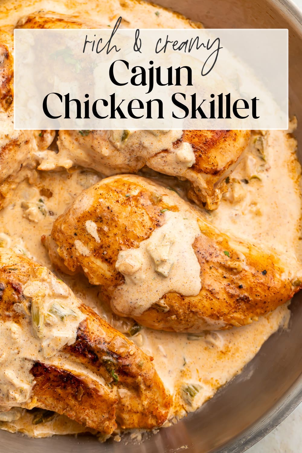 Pin graphic for creamy Cajun chicken skillet.