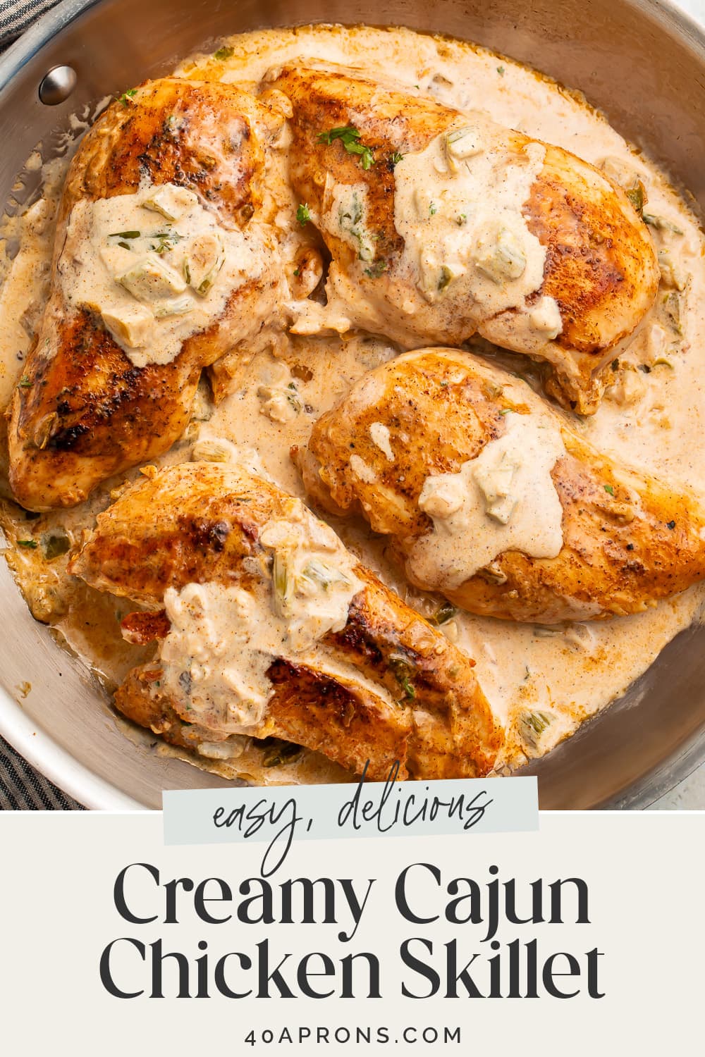 Pin graphic for creamy Cajun chicken skillet.